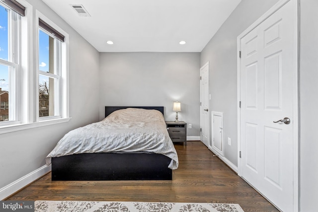 bedroom with dark hardwood / wood-style flooring