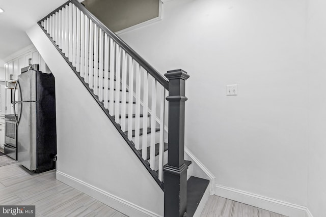 staircase featuring wood-type flooring