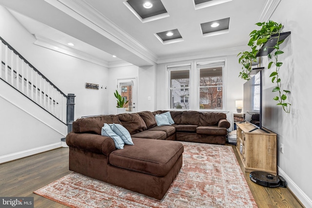 living room with coffered ceiling, crown molding, and hardwood / wood-style flooring