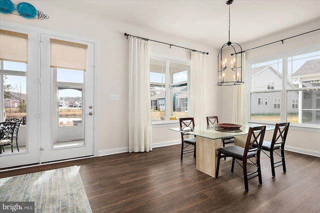 dining room with a chandelier, dark hardwood / wood-style floors, and a healthy amount of sunlight