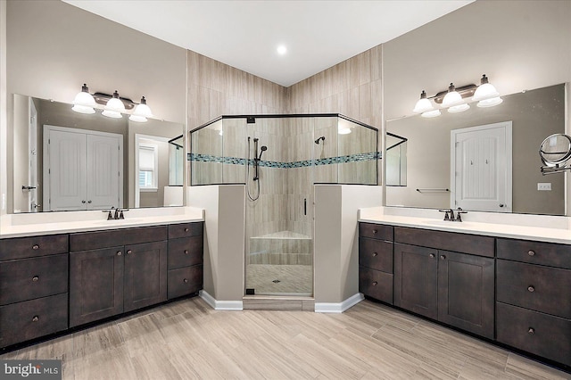 bathroom with vanity, hardwood / wood-style floors, and an enclosed shower