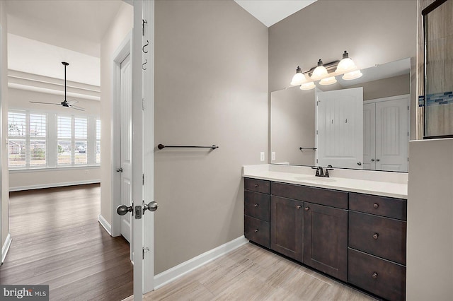 bathroom with ceiling fan, vanity, and hardwood / wood-style floors