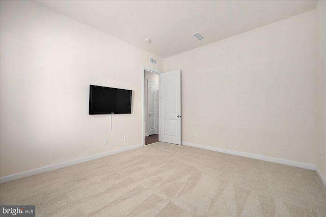 unfurnished room with light colored carpet