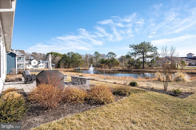 view of yard featuring a patio area and a water view