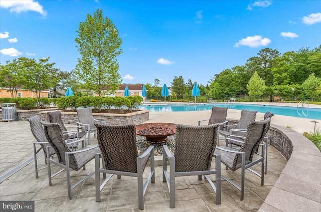 view of swimming pool featuring central AC unit and a patio area