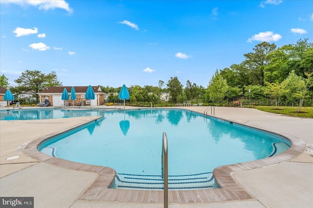 view of swimming pool featuring a patio area