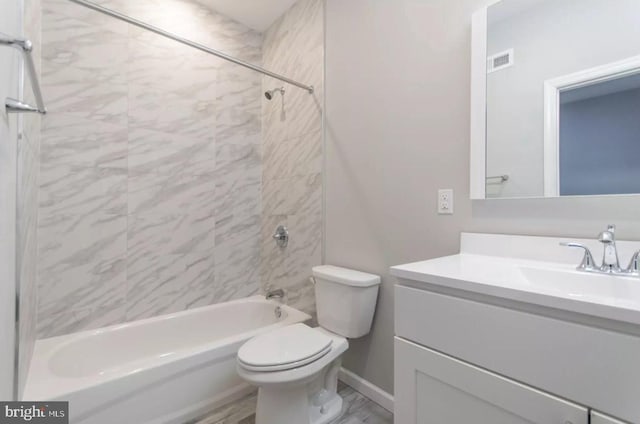 full bathroom featuring toilet, vanity, and tiled shower / bath