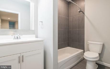 full bathroom with tile patterned floors, vanity, toilet, and tiled shower / bath combo