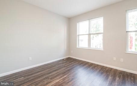 spare room featuring dark hardwood / wood-style floors