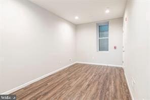 empty room with hardwood / wood-style floors