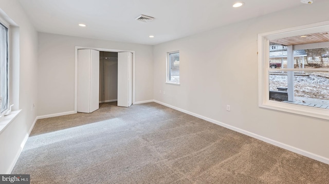 unfurnished bedroom featuring carpet floors and a closet