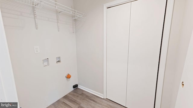 laundry area featuring washer hookup and light hardwood / wood-style floors