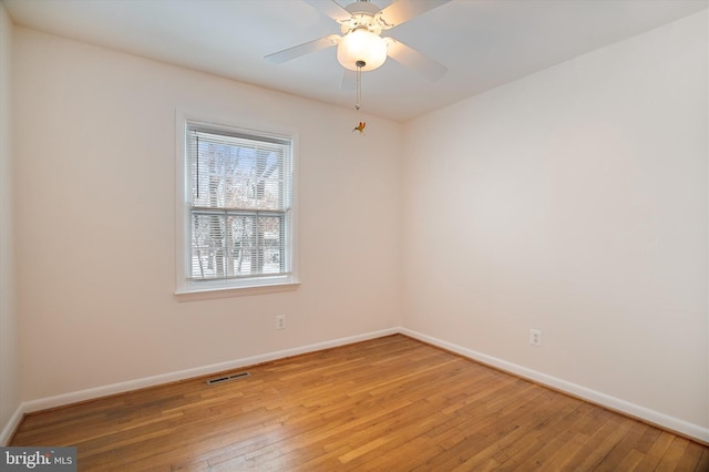 spare room featuring wood-type flooring and ceiling fan