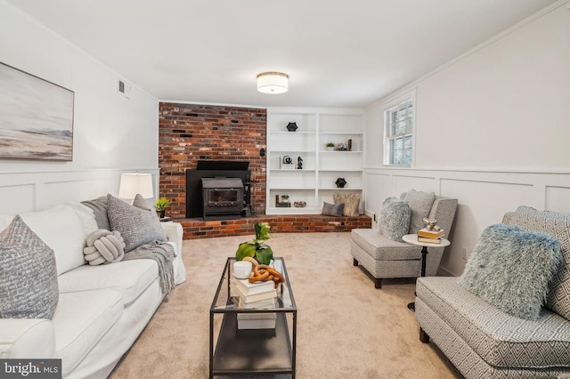 carpeted living room with built in shelves, ornamental molding, and a wood stove