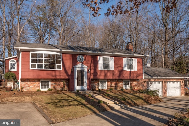 bi-level home with a garage and a front yard