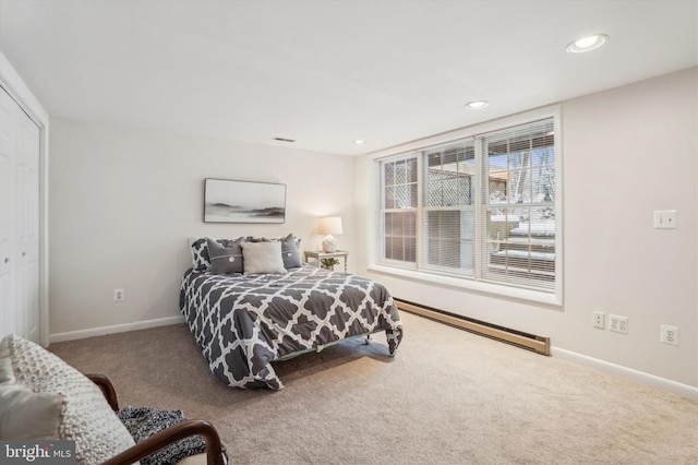 bedroom featuring a baseboard radiator, a closet, and carpet