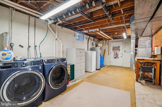 basement featuring water heater, heating unit, and washer and dryer