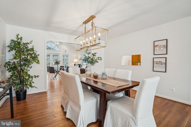 dining room with dark hardwood / wood-style flooring