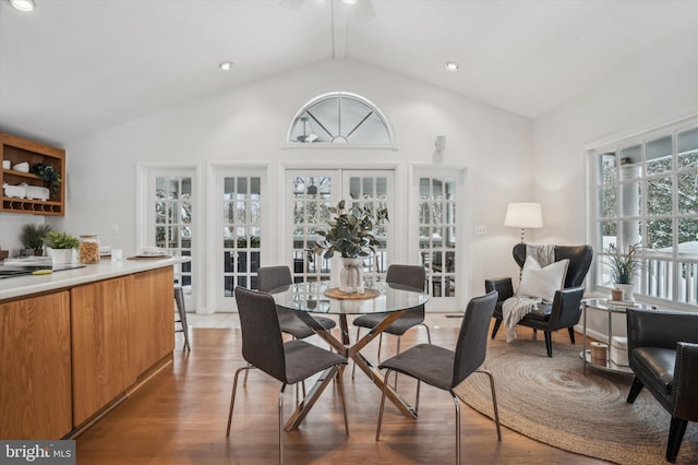 dining area with french doors, lofted ceiling, and dark hardwood / wood-style flooring