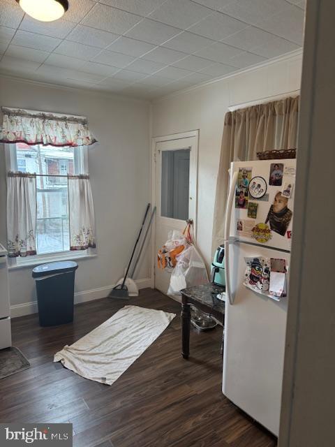 sitting room with dark hardwood / wood-style flooring and crown molding