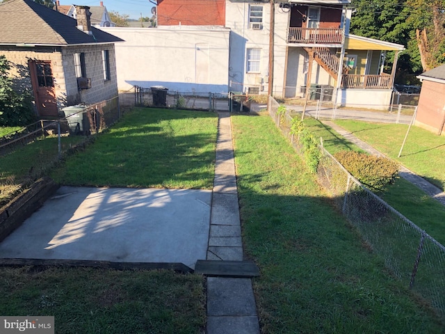 view of yard featuring a balcony and a patio