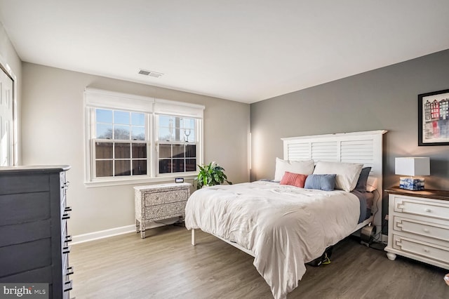 bedroom with hardwood / wood-style flooring