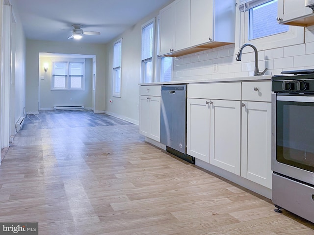 kitchen with stainless steel dishwasher, tasteful backsplash, white cabinetry, and range