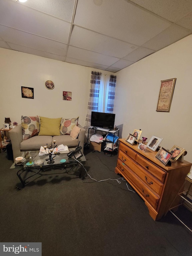 carpeted living room with a drop ceiling