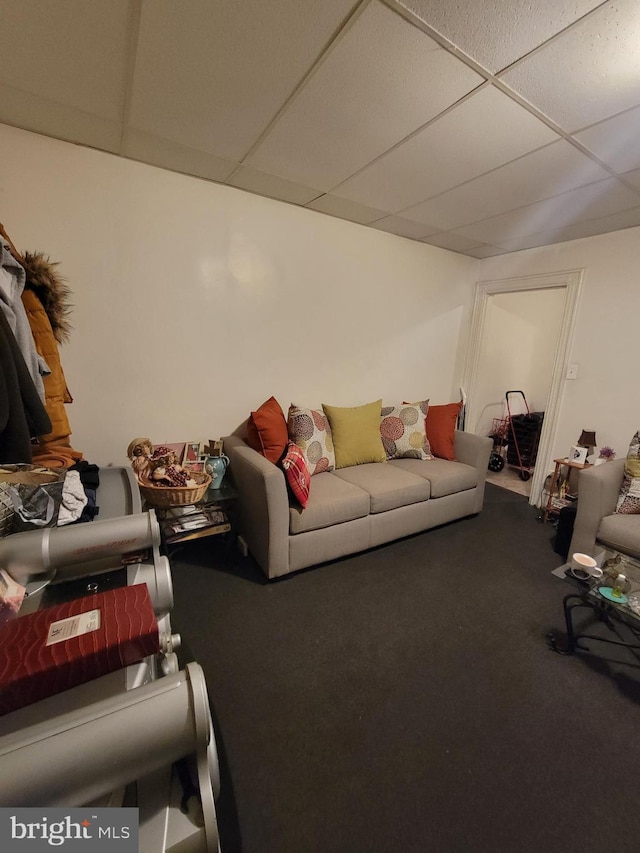 living room with a drop ceiling