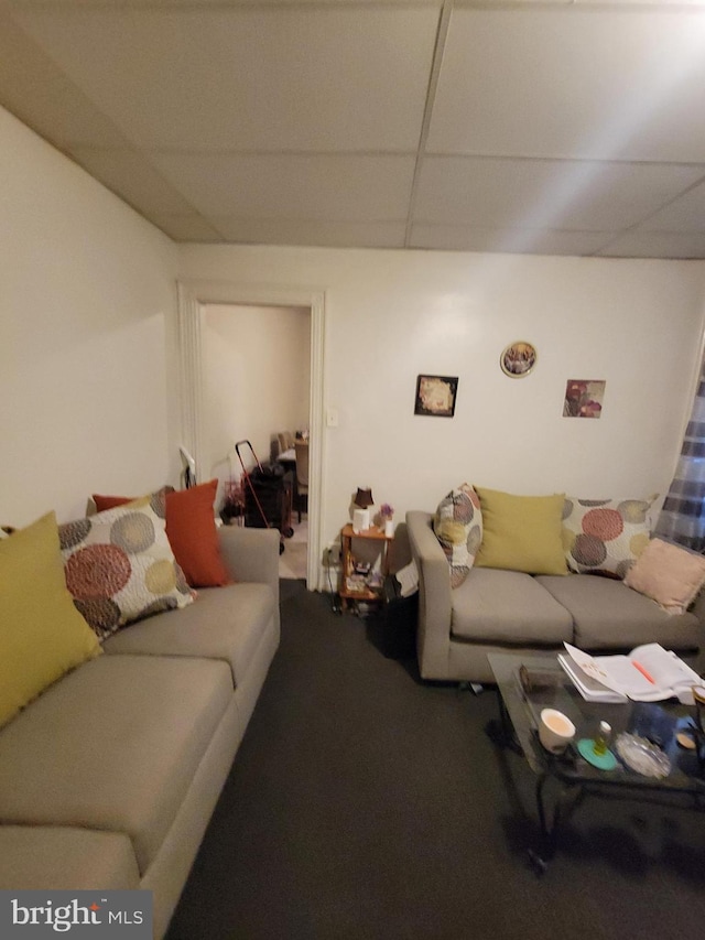 living room featuring a paneled ceiling