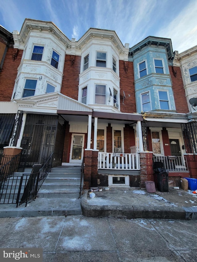 townhome / multi-family property with covered porch