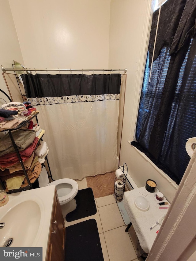 bathroom featuring tile patterned floors, walk in shower, vanity, and toilet