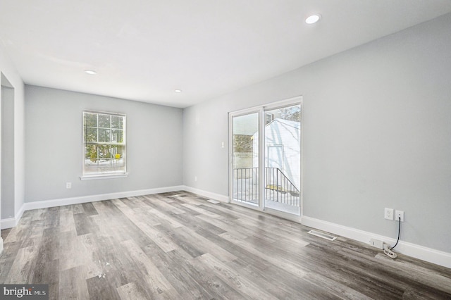 empty room featuring light hardwood / wood-style flooring and a healthy amount of sunlight