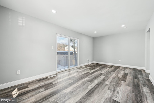 unfurnished room with hardwood / wood-style flooring