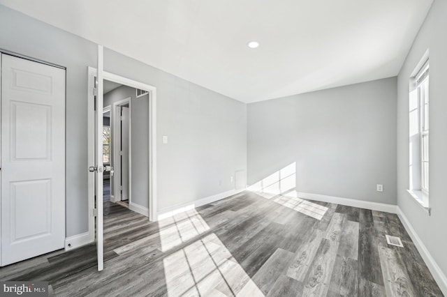 empty room featuring dark hardwood / wood-style floors and a wealth of natural light