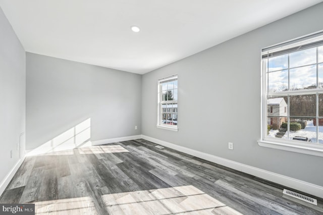 unfurnished room with dark wood-type flooring