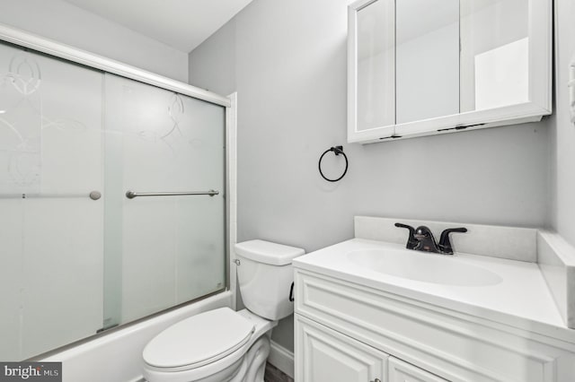 full bathroom featuring vanity, enclosed tub / shower combo, and toilet