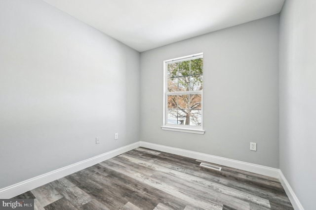 unfurnished room with hardwood / wood-style flooring