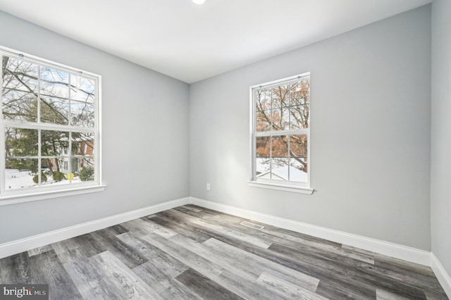 unfurnished room with hardwood / wood-style flooring