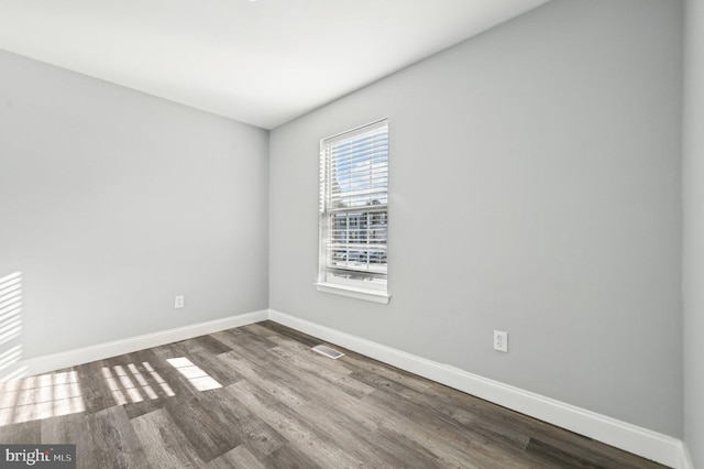 spare room featuring hardwood / wood-style flooring