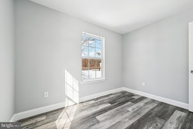 spare room featuring dark hardwood / wood-style floors