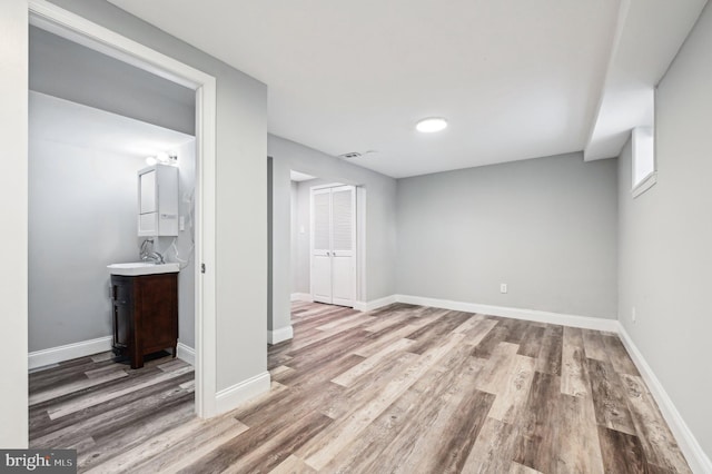 interior space with light hardwood / wood-style floors and sink