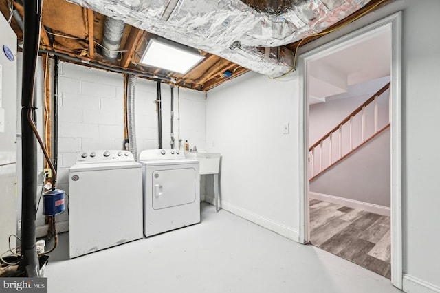 clothes washing area featuring separate washer and dryer