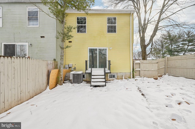 snow covered property featuring cooling unit