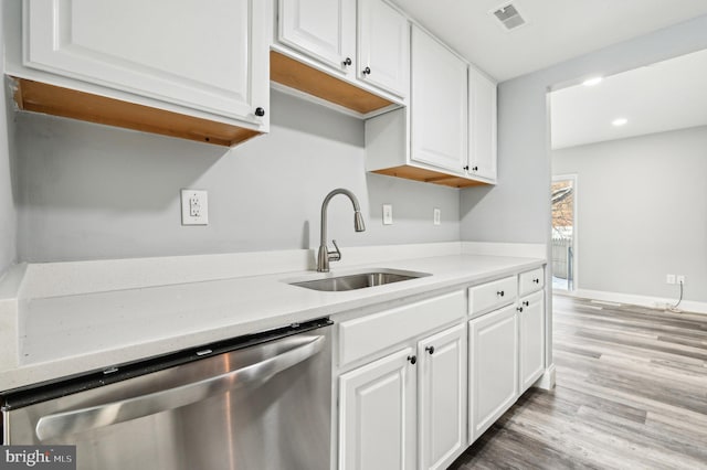 kitchen featuring dishwasher, white cabinets, light hardwood / wood-style floors, and sink