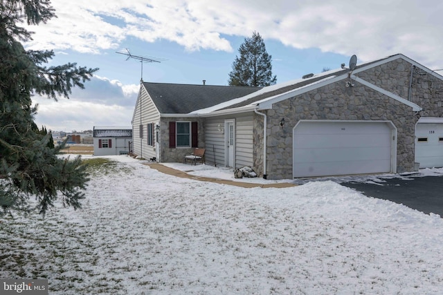 view of snowy exterior featuring a garage