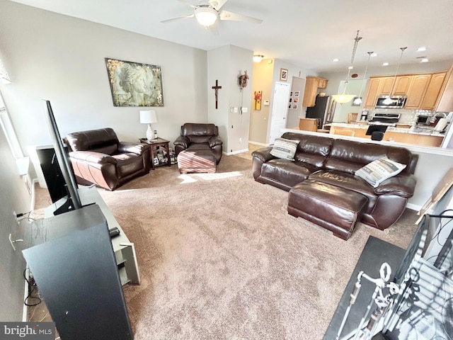 carpeted living room with ceiling fan