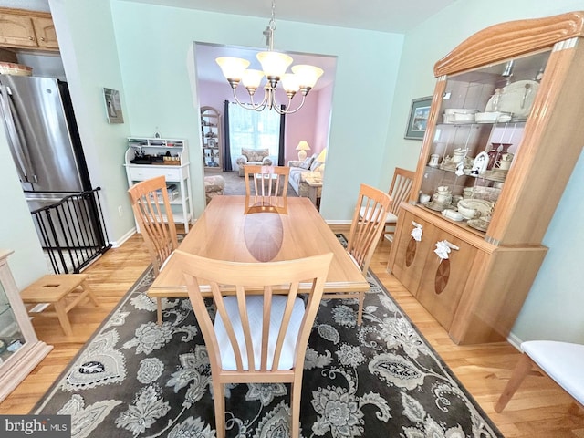 dining room featuring a chandelier and wood-type flooring