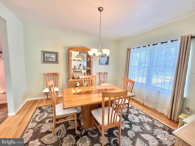 dining space featuring a chandelier and hardwood / wood-style flooring