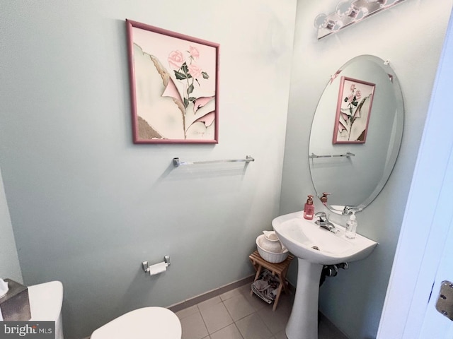 bathroom featuring tile patterned flooring and toilet